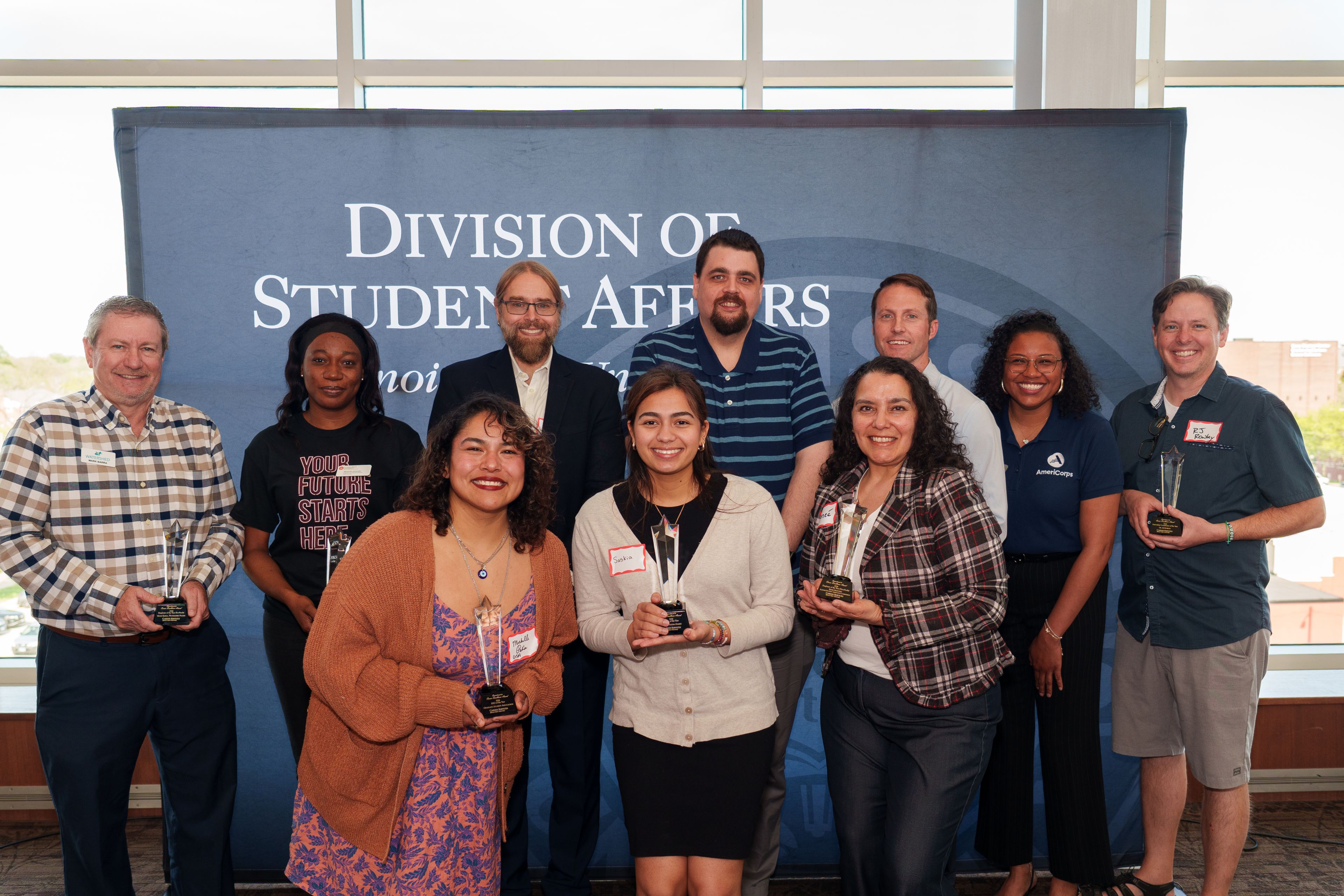 Commitment to career excellence award recipients in front of Division of student affairs backdrop