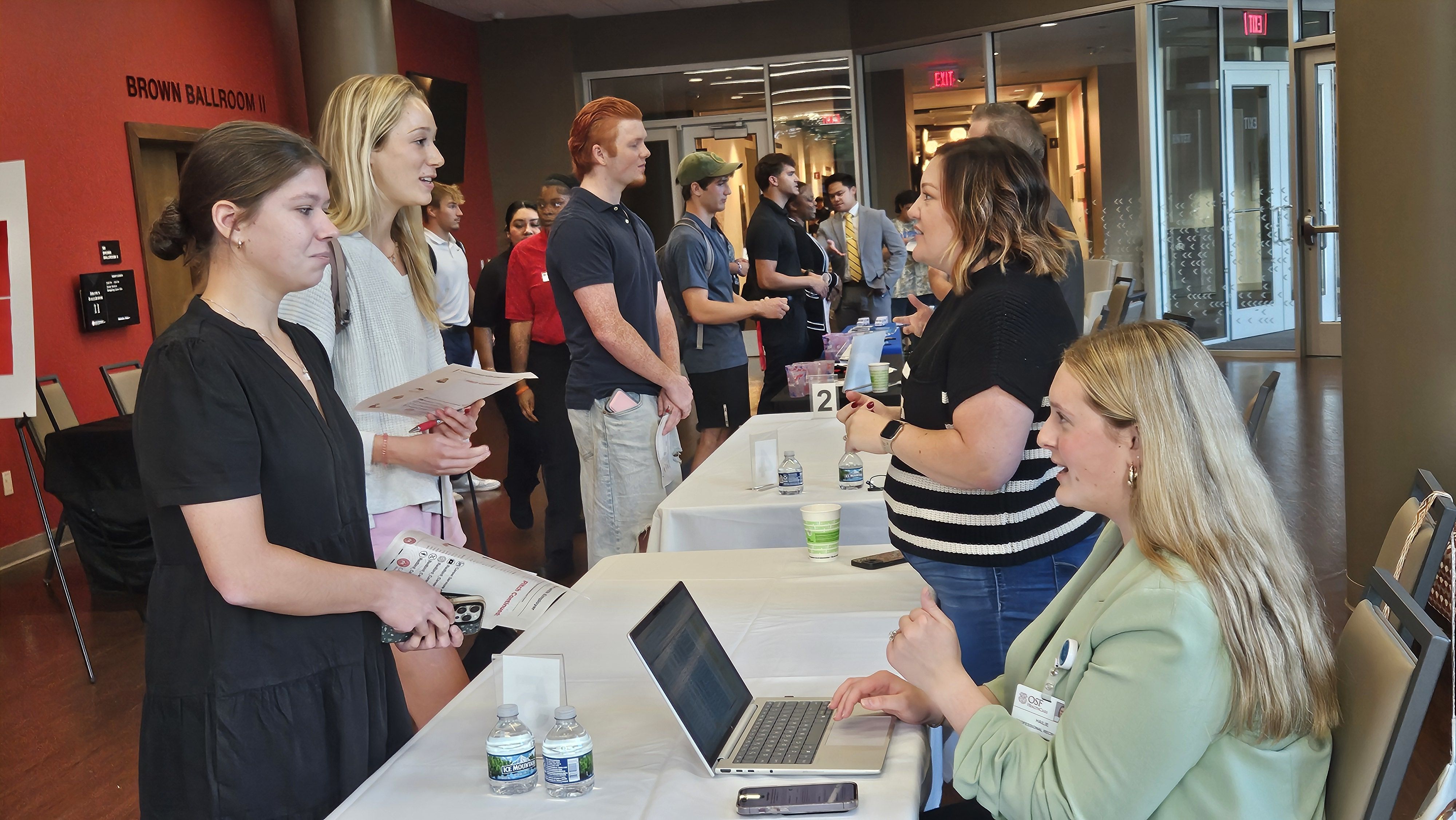 Career fair tables and attendees