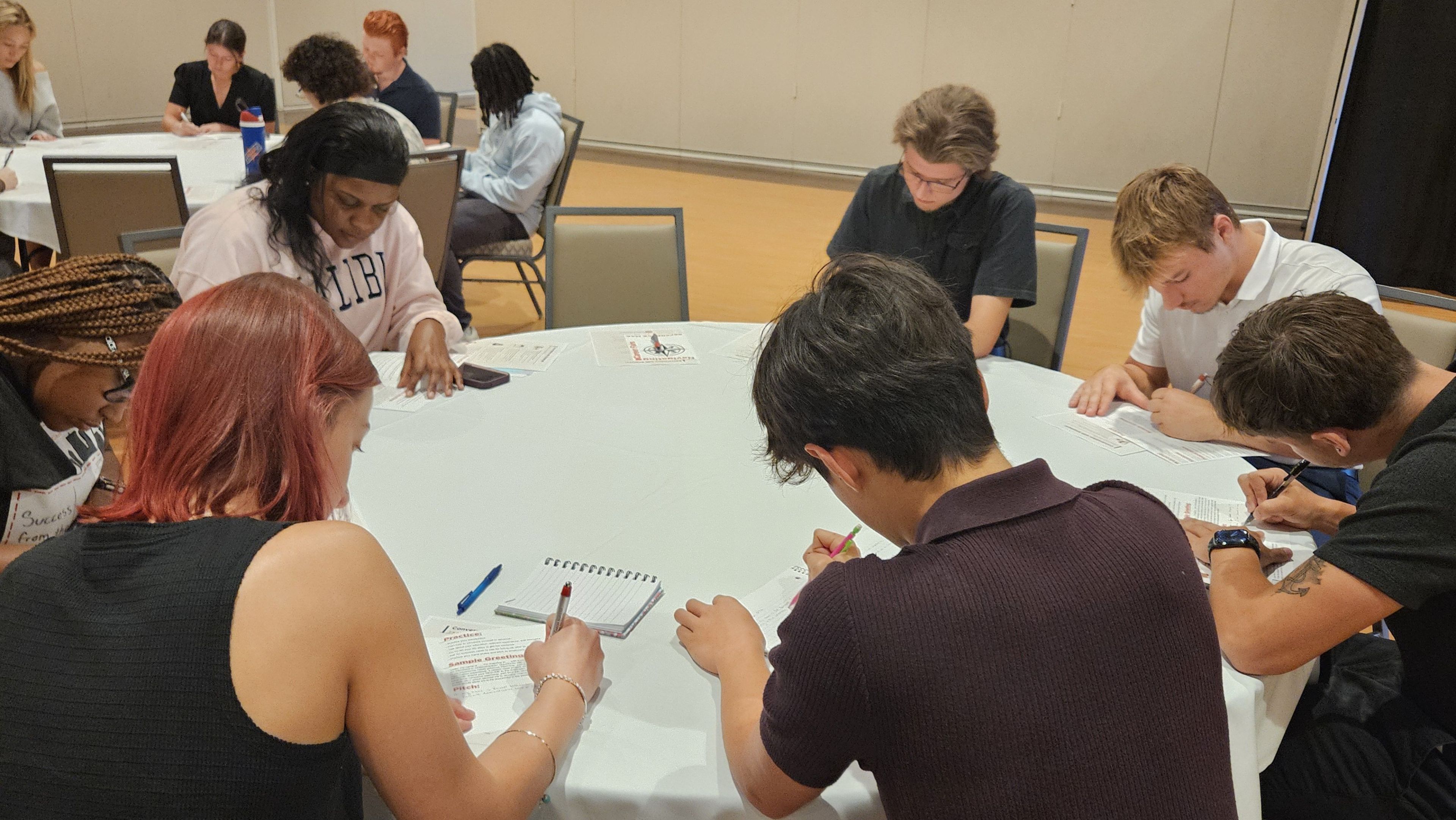 Career fair attendees at a table doing an activity