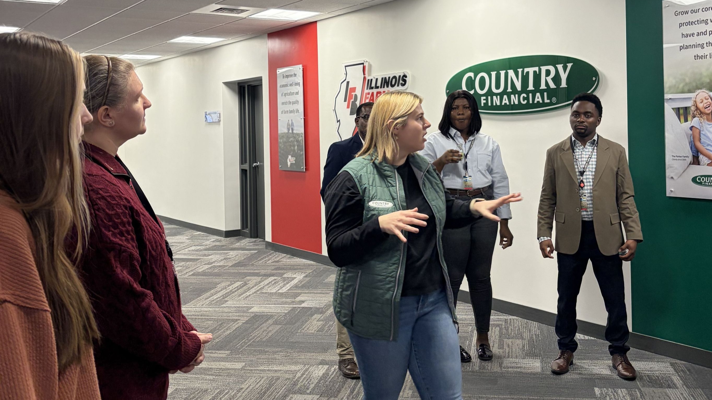 students being led through Country offices by a representative